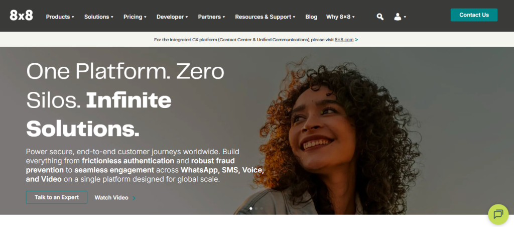 8x8 homepage with headline "One Platform. Zero Silos. Infinite Solutions." — a unified CX platform covering frictionless authentication, fraud prevention, and seamless engagement across WhatsApp, SMS, Voice, and Video at global scale, with a smiling woman looking upward in the hero image